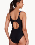 Women in Classique Ankor Clipback one piece swimwear in black with wave patterns by Zoggs with v neck and full coverage and eco sensitive fabric for B-E cup size bust back view