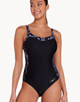 Women in Classique Ankor Clipback one piece swimwear in black with wave patterns by Zoggs with v neck and full coverage and eco sensitive fabric for B-E cup size bust front view
