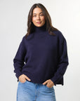 Woman wearing mixed wool navy jumper with turtleneck by brand Stella & Gemma front view