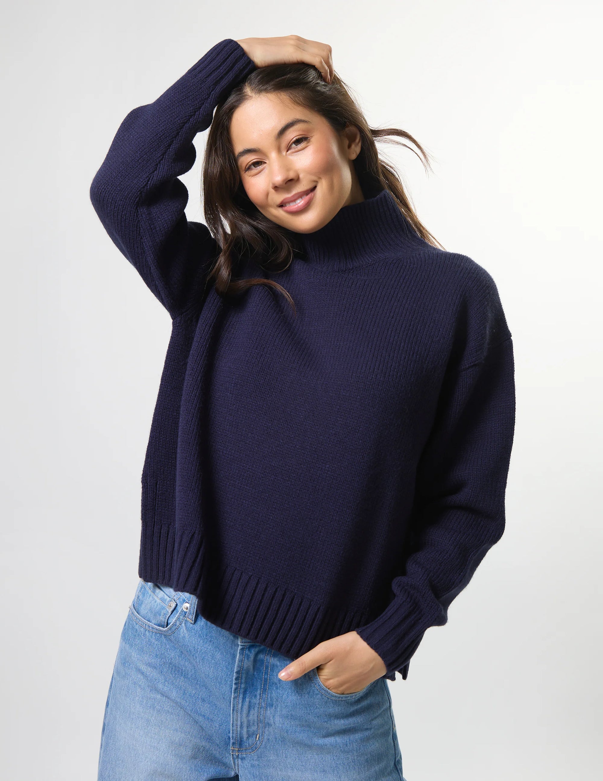 Woman wearing mixed wool navy jumper with turtleneck by brand Stella & Gemma posed front view
