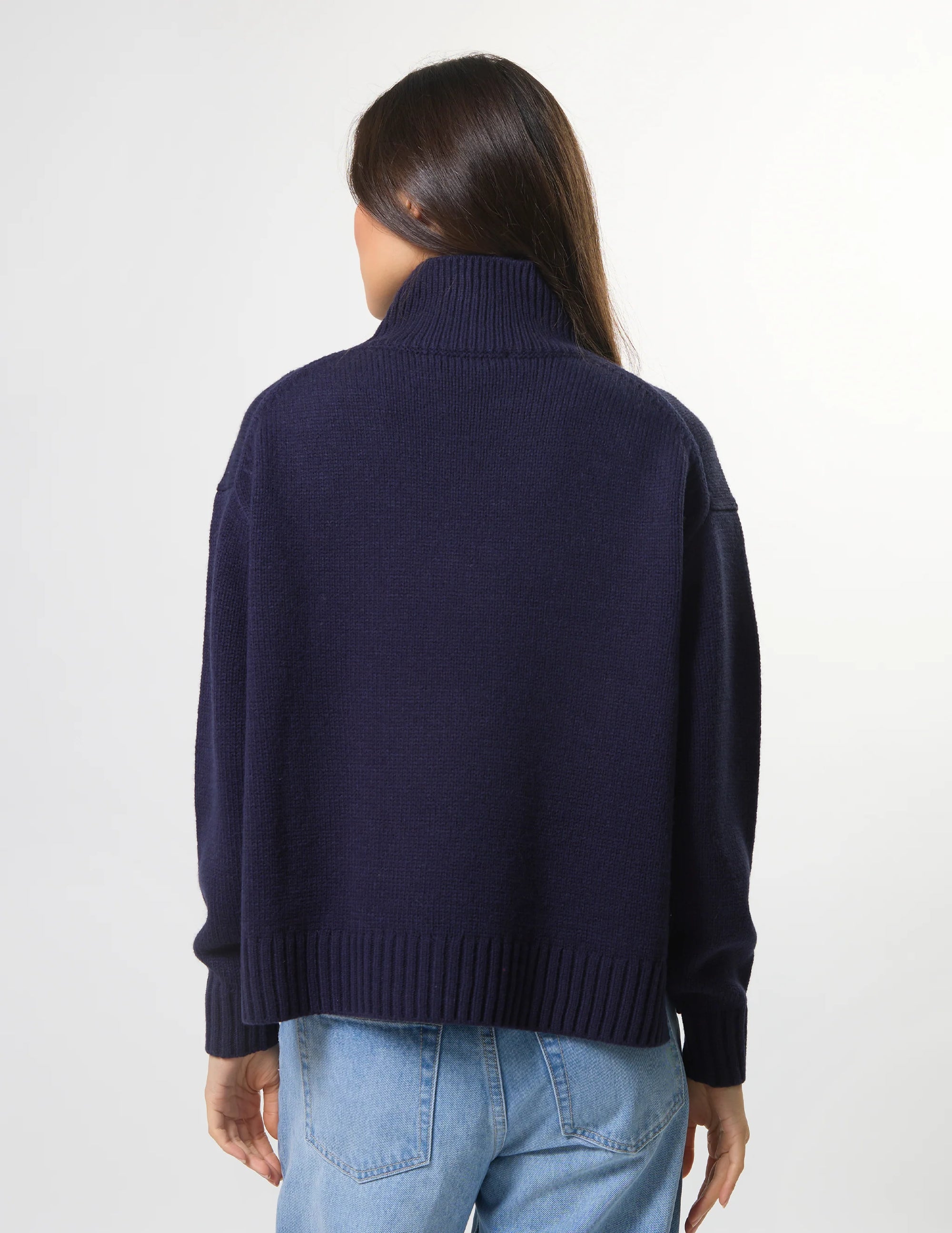 Woman wearing mixed wool navy jumper with turtleneck by brand Stella & Gemma back view