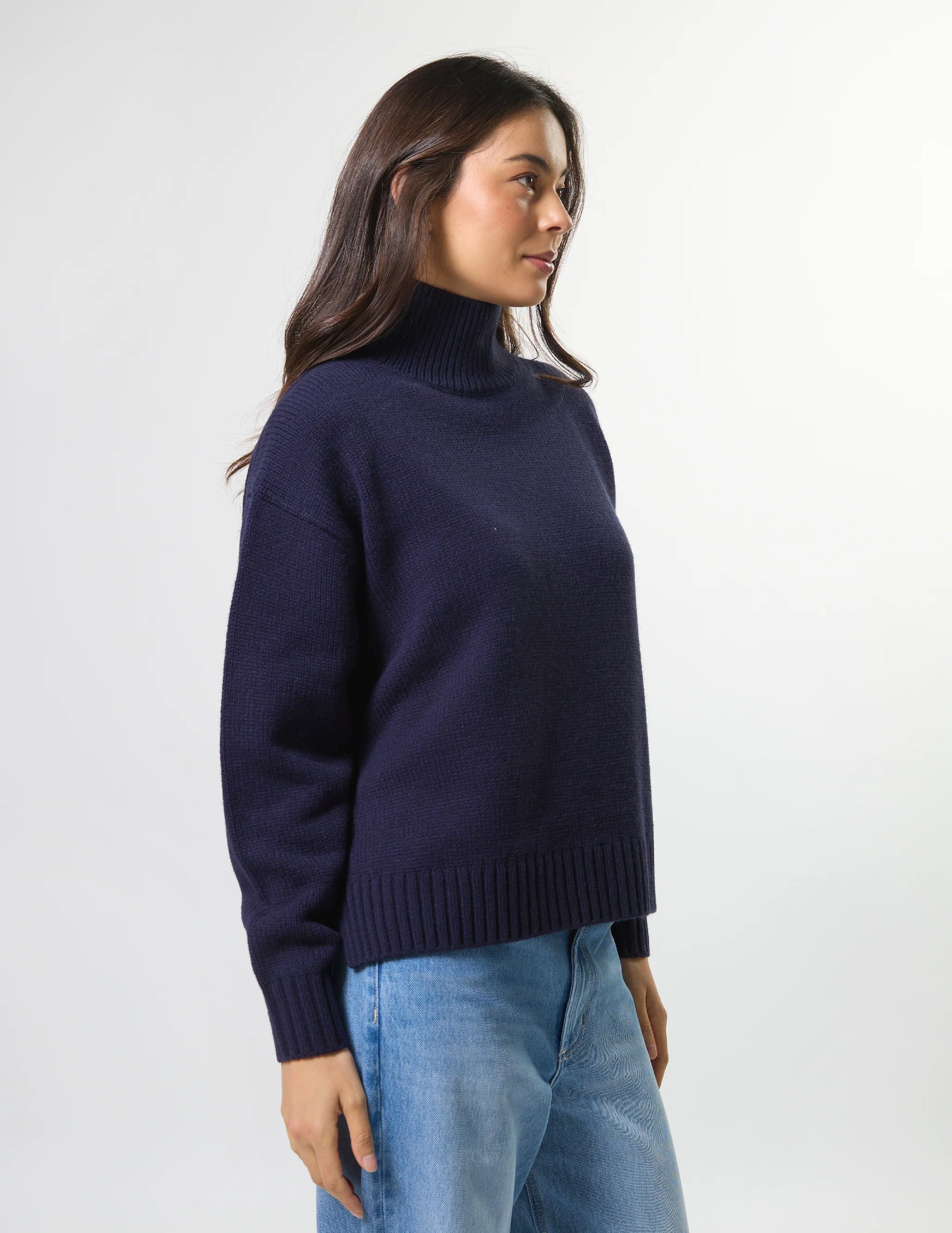 Woman wearing mixed wool navy jumper with turtleneck by brand Stella & Gemma side view