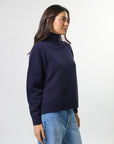 Woman wearing mixed wool navy jumper with turtleneck by brand Stella & Gemma side view