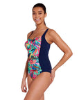 Women wearing Kuringai Ruched Front One Piece swimsuit in navy with green pink and blue floral ruched front panel for C-E cup bust size in chlorine resistant eco sensitive fabric with good coverage by swim brand Zoggs with white background side view