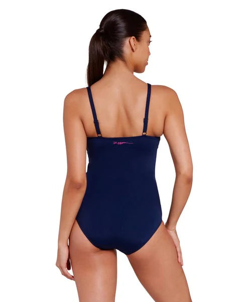 Women wearing Kuringai Ruched Front One Piece swimsuit in navy with floral ruched front panel for C-E cup bust size in chlorine resistant eco sensitive fabric with good coverage by swim brand Zoggs with white background back view